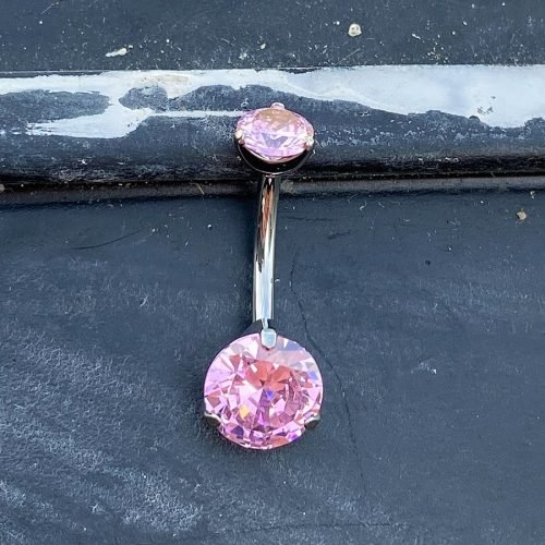 Piercing de ombligo. De titanio y con 2 zirconias rosas engarzadas